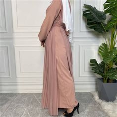 This beautiful nida pleated jumpsuit dress is the perfect outfit for any occasion. Includes with a belt, wide legged pants, long-sleeved arms, and a chiffon dress overlay. Available in 5 colours. Party Long Sleeve Chiffon Abaya, Elegant Workwear Abaya In Maxi Length, Spring Workwear Abaya, Beige Pleated Maxi Dress, Flowy Long Sleeve Belted Dresses, Elegant Spring Belted Pleated Dress, Summer Party Abaya With Long Sleeves, Summer Long Sleeve Party Abaya, Summer Party Long Sleeve Abaya