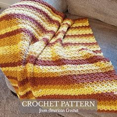 a crocheted blanket sitting on top of a couch