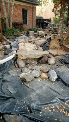 the rocks are being laid out on the ground to be used as a water feature