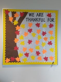 a bulletin board that says, we are grateful for fall and leaves on the wall