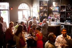 a group of people sitting around a bar