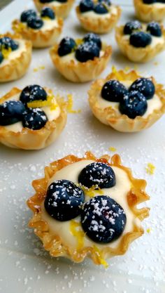 small pastries with blueberries and lemon on them