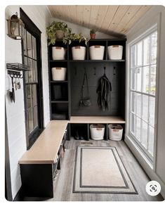 the inside of a small room with many pots and plants on shelves, along with other items