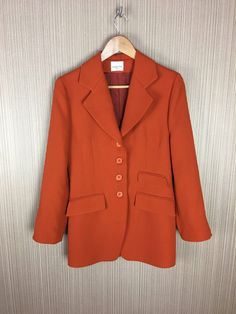 Vintage Orangle Claude Zana Jacket Made in France Women's retro clothing Wear: Good vintage condition. Measurements: Shoulders: 43 cm or 17 inch Chest: 47 cm or 18.5 inch Length: 82 cm or 32.3 inch Classic Long Sleeve Orange Outerwear, Classic Orange Blazer For Workwear, Classic Orange Blazer For Work, Fitted Orange Outerwear With Notch Lapel, Formal Orange Outerwear For Fall, Retro Formal Fall Outerwear, Vintage Spring Blazer With Welt Pockets, Vintage Workwear Sport Coat With Suit Collar, Vintage Sport Coat With Lapel Collar For Workwear