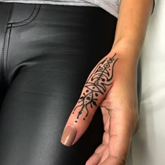 a woman's hand with a tattoo on it