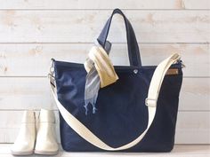 a blue bag and two pairs of white shoes