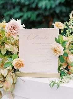 a table topped with lots of flowers next to a white sign that says graced