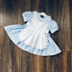 Beautiful Alice in Wonderland inspired dress, completely hand made in 100 % cotton.  The main fabric is baby blue and the contrast apron is pure white. The apron is separate so the dress can also be worn alone. I also offer a separate tutu skirt for a super full and puffy look.  I offer the dress in both standard and custom sizing. Please send a message if you would like custom fit at no extra charge. This dress is hand made to order. The estimated delivery time can be found under the shipping t White Princess Style Cotton Dress, Princess Style White Dress For Tea Party, White Cotton Princess Dress, White Princess Dress For Tea Party, Blue Ruffled Dresses For Tea Party, Cute White Cotton Pinafore Dress, Whimsical Blue Costume Dresses, Cute Blue Costume Dress, Blue Short Sleeve Dress For Birthday