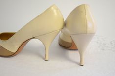 "Vintage 1950s cream and beige colorblocked leather stilettos. Made by Renazzo. Marked a size 7 1/2 AAAA, but would fit up to an 8 super narrow based on measurements (allow room for the pointy toe). They measure 10\" long inside from toe to heel and 2 5/8\" wide. The heel is 3 1/2\" tall. In fair condition, with some wear to the soles, some faint scuffs, and missing heel caps. ---> If you need an order shipped by a particular date or shipped via a quicker method, please ask PRIOR to purchase Vintage Cream Heels With Almond Toe, Retro Cream Heels For Formal Occasions, Vintage Cream High Heels, Vintage Cream Open Toe Heels, Vintage Beige Pointed Toe Heels, Vintage Beige High Heel Heels, Leather Stilettos, Neutral Heels, Womens Pumps