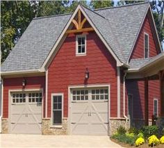 a red house with two garages and three windows