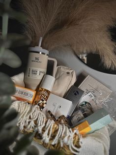 an assortment of items sitting on top of a table next to a potted plant