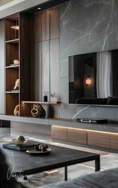 a modern living room with black furniture and marble wallpaper, along with a large flat screen tv mounted on the wall