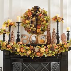 a decorated mantle with candles and wreaths on it