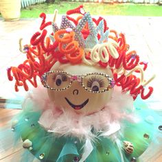 an egg wearing a tiara and glasses on top of a table