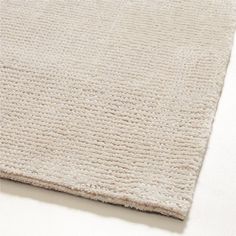 a white rug is laying on top of a table and it looks like the fabric has been woven