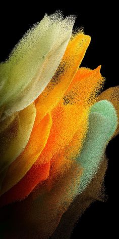 multicolored powder on black background with reflection