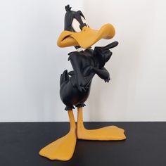 a rubber duck is posed on a black surface