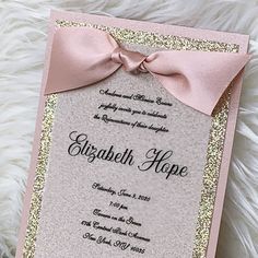 a pink and gold wedding card with a bow