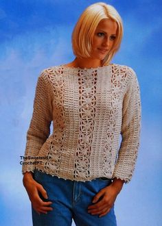 a woman is posing for a photo in front of a blue background wearing a knitted sweater