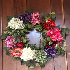 a wreath made out of flowers sitting on top of a wooden floor