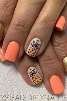 an orange and white manicure with a pineapple on it