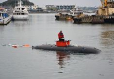 a man riding on the back of a small boat