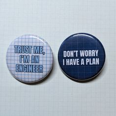 two buttons that say trust me i'm an engineer and don't worry i have a plan