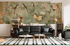 a living room with floral wallpaper and black leather couches in front of a large painting