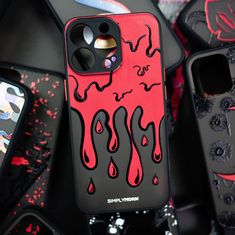 an iphone case with red and black designs on it