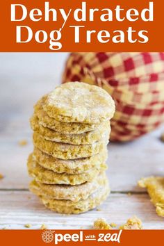 a stack of dog treats sitting on top of a wooden table next to an apple