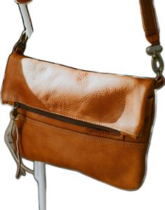 Brown Leather Lined Crossbody Saddle Bag, Brown Leather Lined Saddle Bag Crossbody, Brown Crossbody Saddle Bag With Leather Lining, Brown Leather-lined Crossbody Saddle Bag, Brown Flap Saddle Bag With Adjustable Strap, Dark Tan Leather Crossbody Shoulder Bag, Brown Flap Bag With Adjustable Strap, Brown Leather Crossbody Saddle Bag, Brown Leather Saddle Bag Crossbody