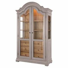 a white china cabinet with drawers and glass doors on the front, against a white background