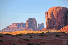 the desert is full of red rocks and green plants