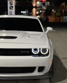 the front end of a white sports car