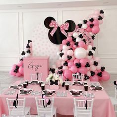 a minnie mouse themed birthday party with pink, black and white balloons