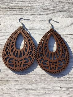 "Beautiful Handmade Wooden Earrings. These wood earrings will go with any outfit, is super lightweight and comfortable. This will be perfect gift for a friend, coworker, daughter, mom, aunt, or just for yourself. Stained Laser cut wooden earrings in your choice of 8 different styles. These earrings are long, if you like to wear long wood earrings, these earrings are perfect for you. #1. Round Flower Round 55mm. Drop length 3\" #2. Brown Flower 70x58mm. Drop length: 3.25\" #3. Light Rhombus 70x51 Laser Engraved Earrings, Mandala Wood, Engraved Earrings, Laser Cut Earrings, Lightweight Earrings, Wooden Earrings, Wood Earrings, Etsy Earrings Dangle, Light Weight Earrings