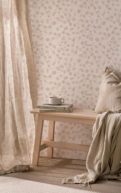 a wooden bench sitting in front of a window next to a wall with leopard print on it