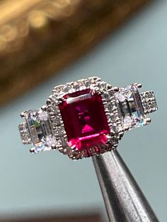 Man made emerald cut ruby, AAA grade laser cut cz set in Sterling silver, ring size 7 1/4 Ruby Diamond Ring With Vvs Clarity And Baguette Cut, Silver Radiant Cut Emerald Ring With Halo Setting, Baguette Cut Ruby Ring With Diamond Center Stone, Baguette Cut Ruby Ring With Diamond, Formal Asscher Cut Ruby Ring With Center Stone, Ruby Ring With Vvs Clarity And Baguette Cut, Silver Emerald Ring With Radiant Cut And Accent Stones, Dazzling Ruby Ring With Vvs Clarity, Baguette Cut Ruby Ring With Vvs Clarity