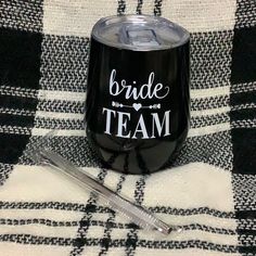 the bride team wine tumbler is next to a straw