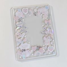 a square shaped mirror with hearts and stars on it