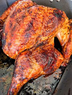 two pieces of meat cooking in a skillet