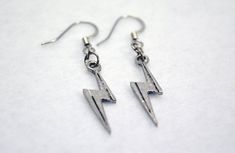 These silver lightning bolt earrings are the ideal accessory to transform your outfit into fandom fun. Pair them with a casual cosplay look for your next convention. Or, wear them any day you want to feel electric (or superpowered or just plain awesome). Silver-plated lightning bolt charms Silver-plated components 1.75 inches long x 0.25 inches wide (4.4 cm x 0.64 cm) Lightning Bolt Scar, Earrings Lightning, Marvel Earrings, Bolt Earrings, Lightning Bolt Earrings, Casual Cosplay, Have Metal, Matching Necklaces, Lightning Bolt