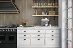 a kitchen with an oven, stove and shelves filled with bottles on the wall behind it