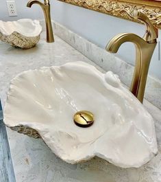 a bathroom sink with a gold faucet and marble counter top next to it