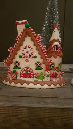 a gingerbread house is decorated with candy canes