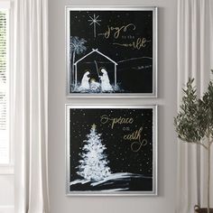 two black and white christmas pictures hanging on the wall