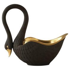 a black swan shaped bowl with gold accents