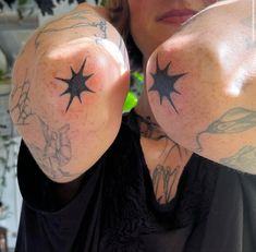 a woman with tattoos on her arms holding up two fingers to show the thumbnails