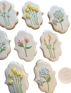 nine decorated cookies with flowers on them