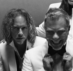 three men in tuxedos posing for the camera